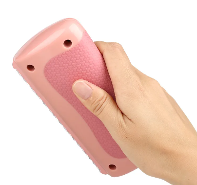 Pink pet hair scraper for removing fur from furniture and carpet