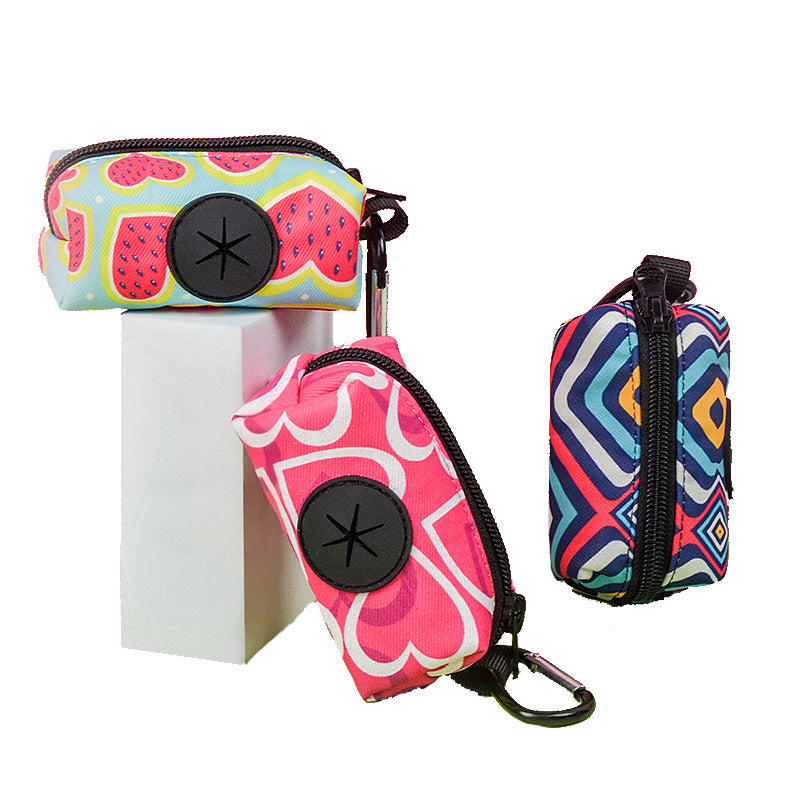 Compact dog poop bag dispenser clipped to leash on hike