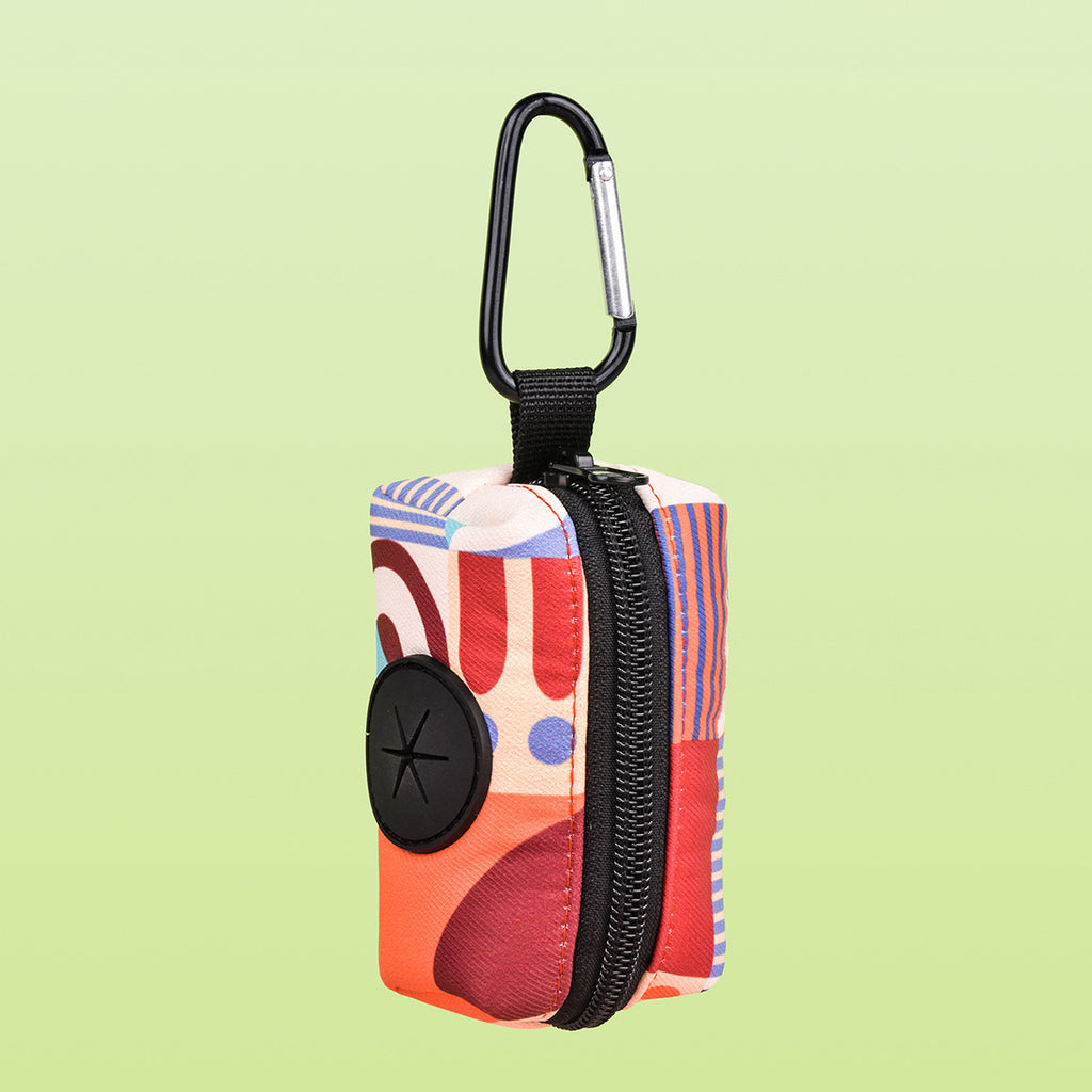 Dog waste bag holder in blue geometrical pattern with loop attachment